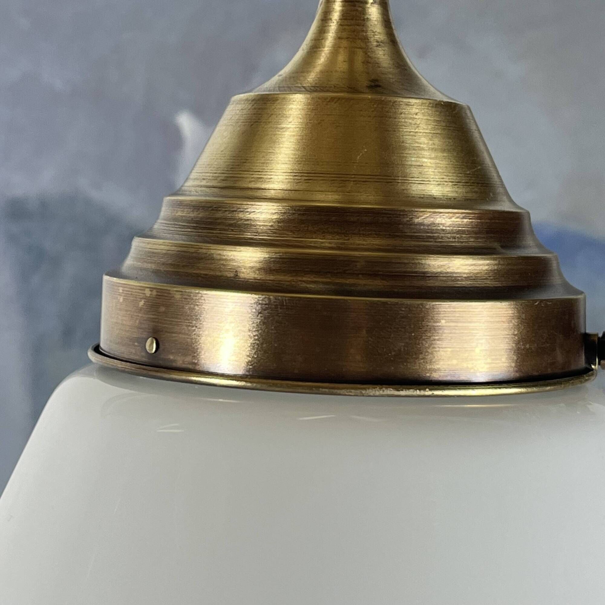 Pair of opaline glass pendant lights in white by Philips and brass from the 1920s.