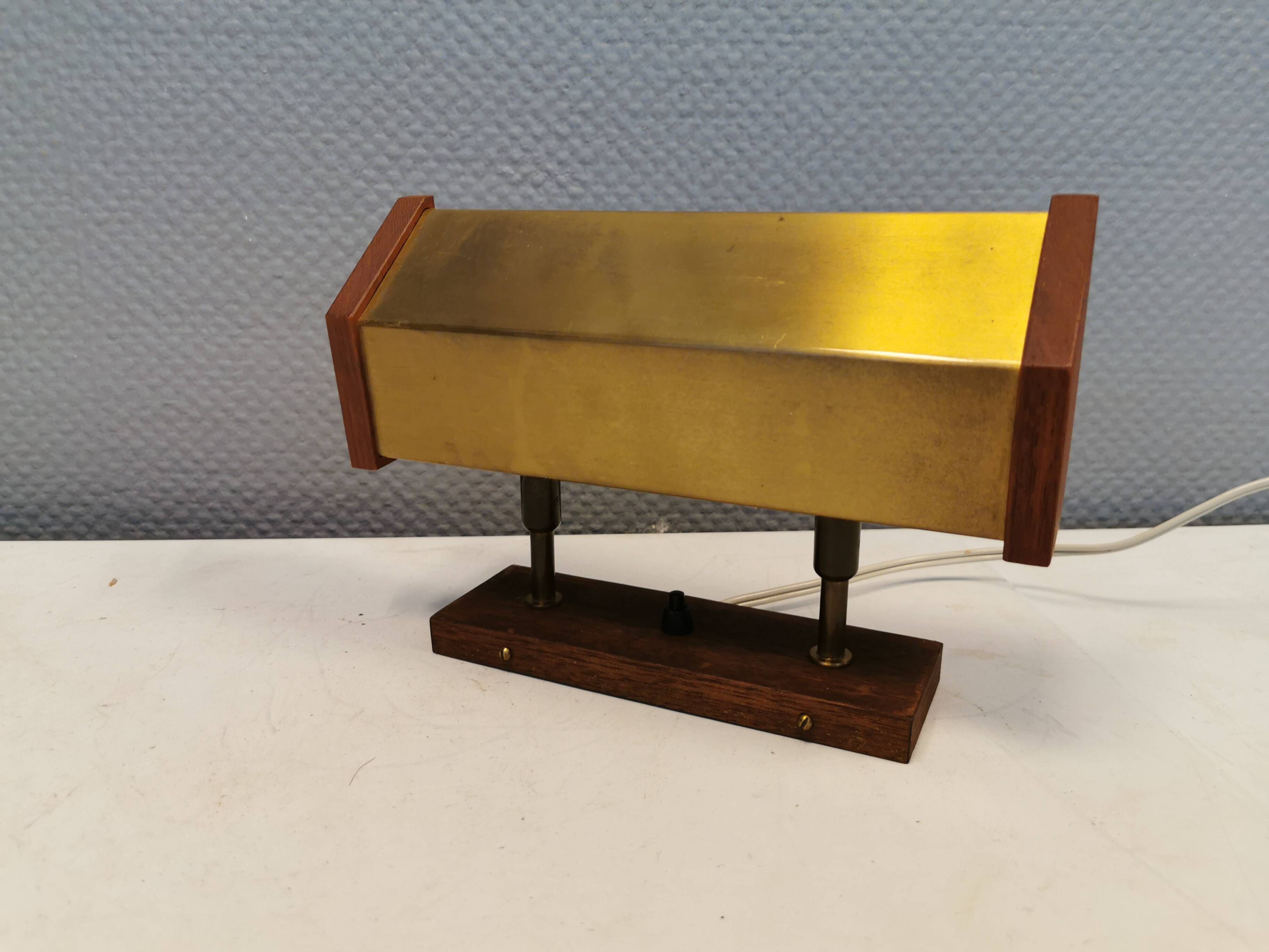 Fuga wall lamp in solid brass and teak wood was designed by Jo Hammerborg for Fog & Mørup in 1966.