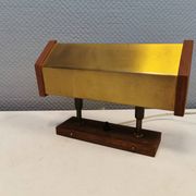Fuga wall lamp in solid brass and teak wood was designed by Jo Hammerborg for Fog & Mørup in 1966.