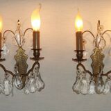Pair of French antique brass double wall lights with assorted crystals.