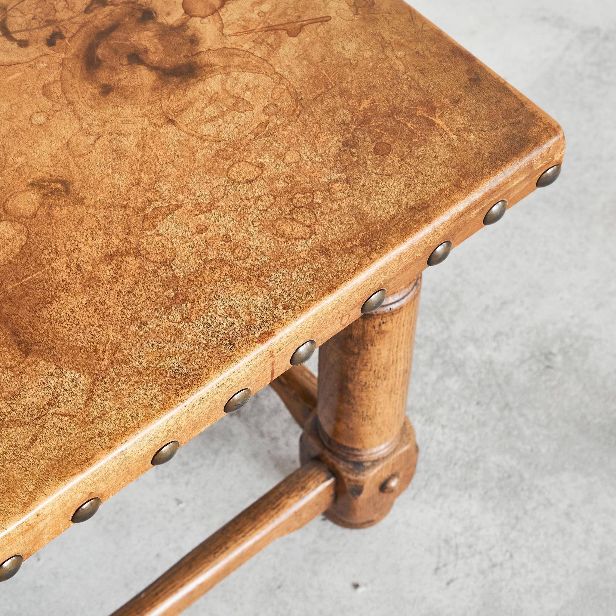 Brutalist coffee table in solid oak, metal, and patinated leather, 1940s.