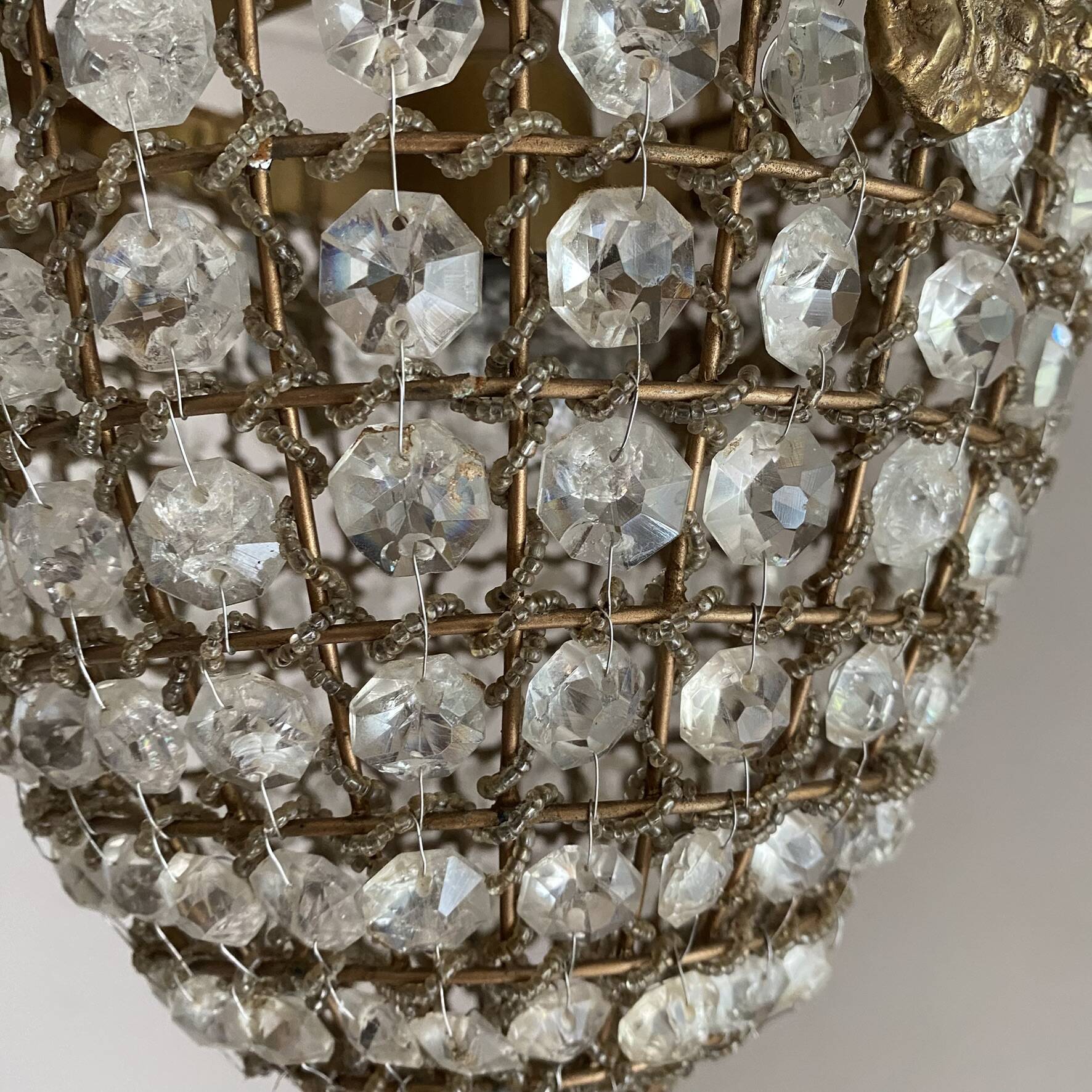Brass basket chandelier with Louis XVI style pendants.