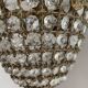 Brass basket chandelier with Louis XVI style pendants.