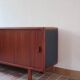 Teak enfilade, sliding doors, black faux leather top, 1970s.