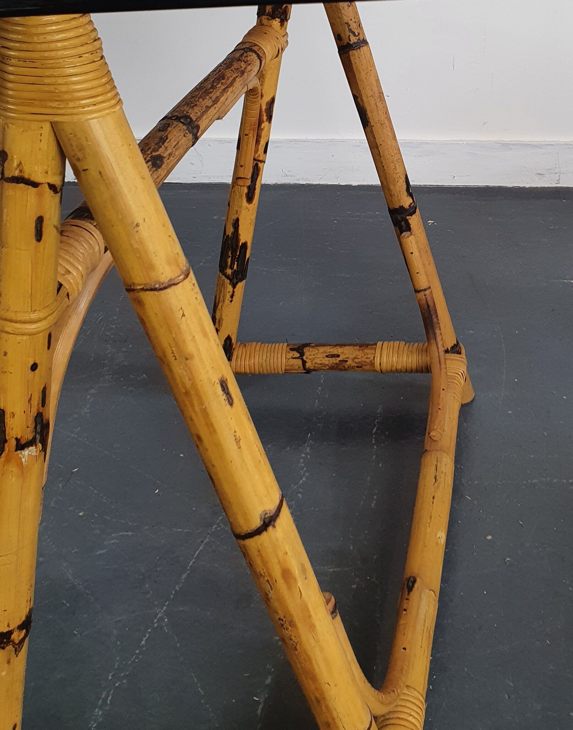 1970s dining table with bamboo trestle legs and smoked glass