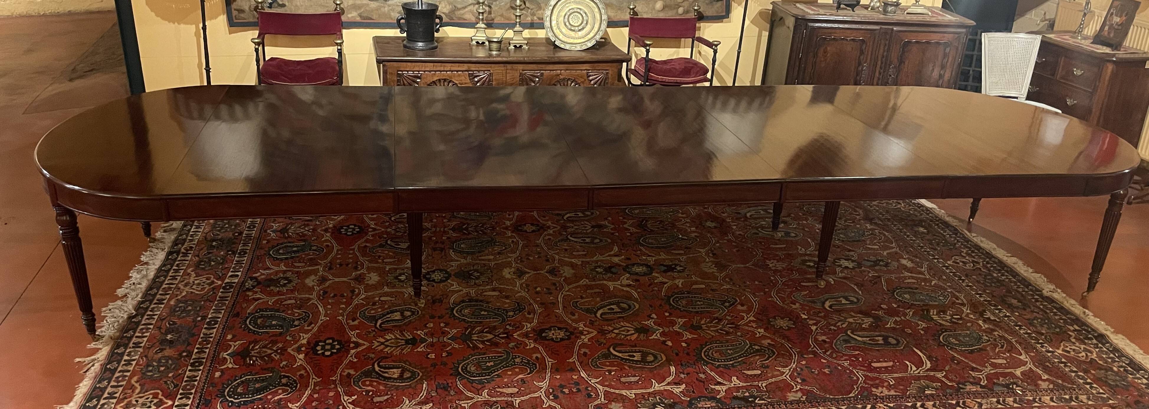 Extensible dining table from the Louis XVI period in mahogany with a banded top.