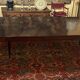 Extensible dining table from the Louis XVI period in mahogany with a banded top.