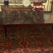 Extensible dining table from the Louis XVI period in mahogany with a banded top.