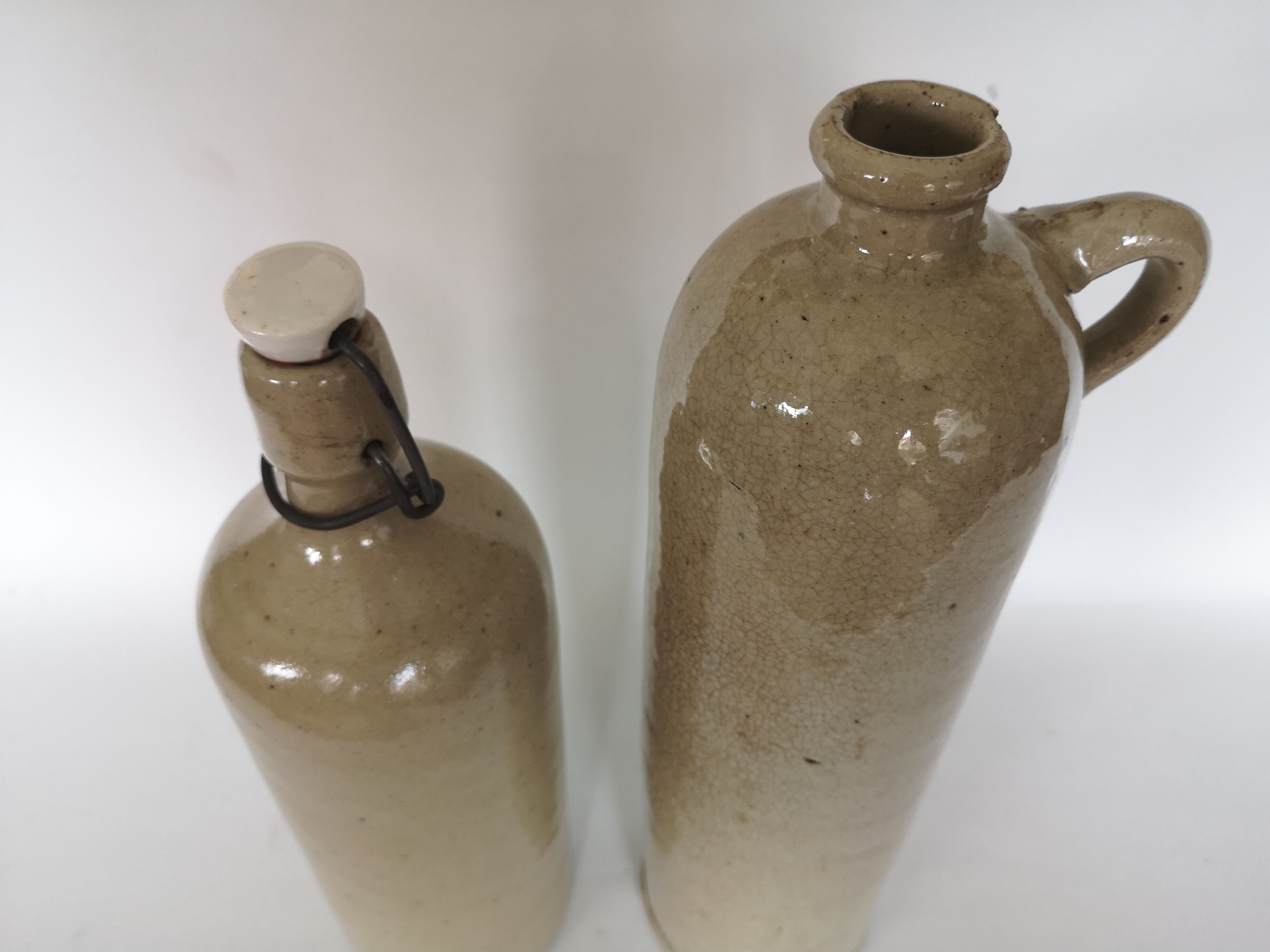 Pair of enamelled sandstone bottles