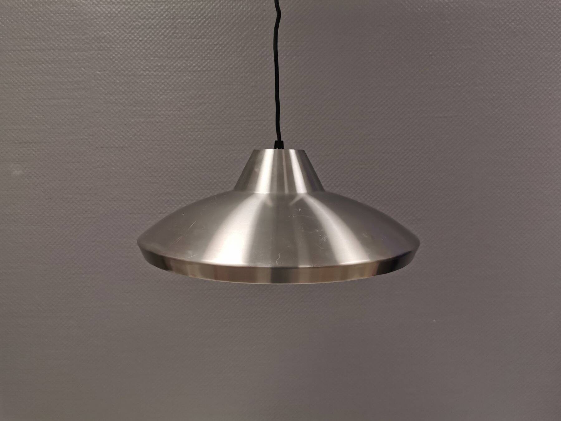 Slim silver-colored hanging lamp with a large diameter. Denmark 1980s