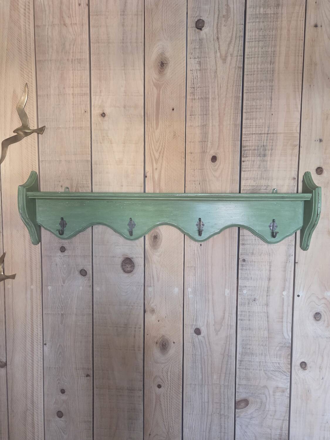 Antique wall shelf with a green patina