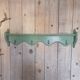 Antique wall shelf with a green patina