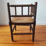 Antique corner chair made of turned wood spindle.