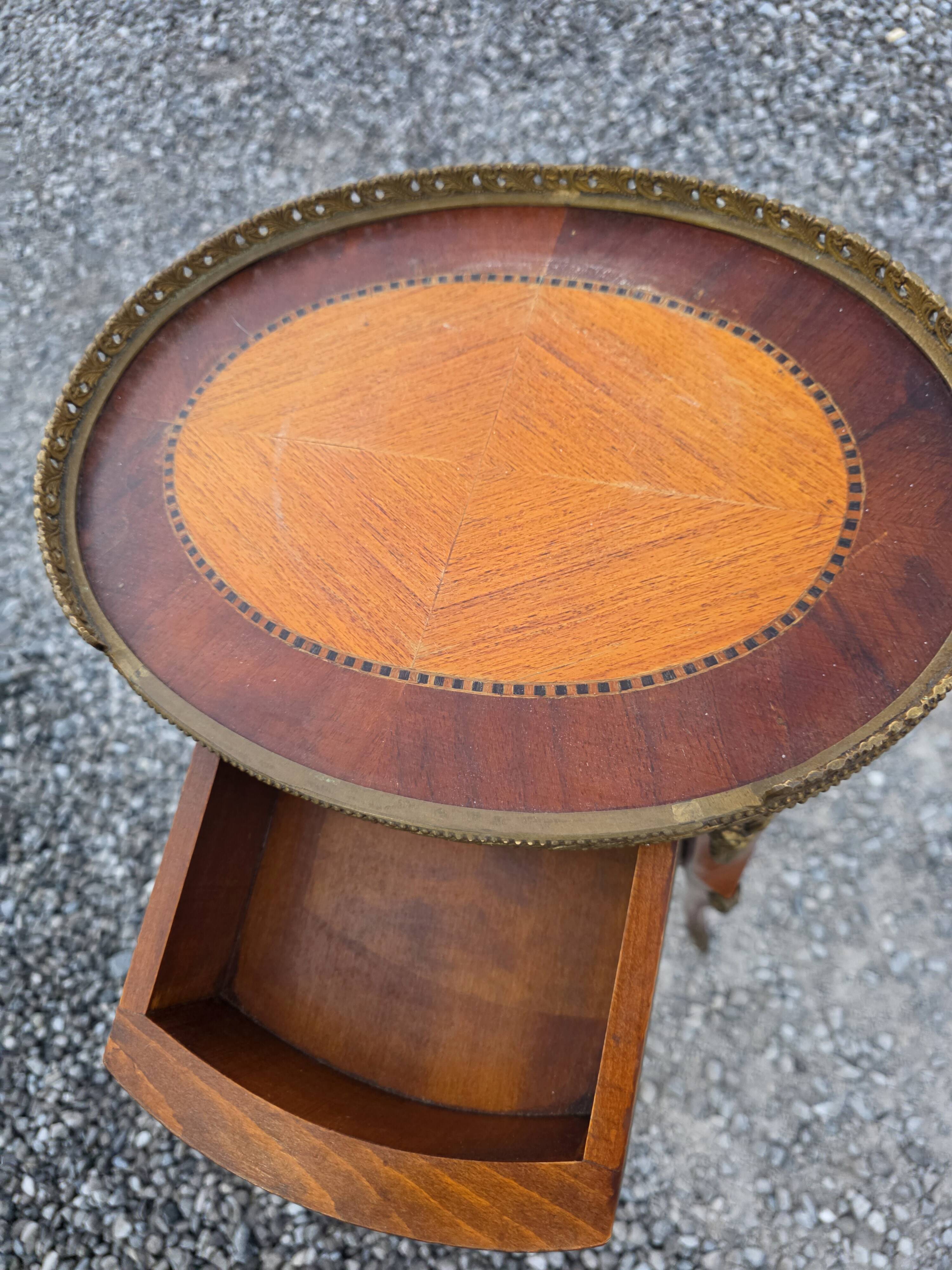 Oval bedside table in Louis XV style with marquetry.