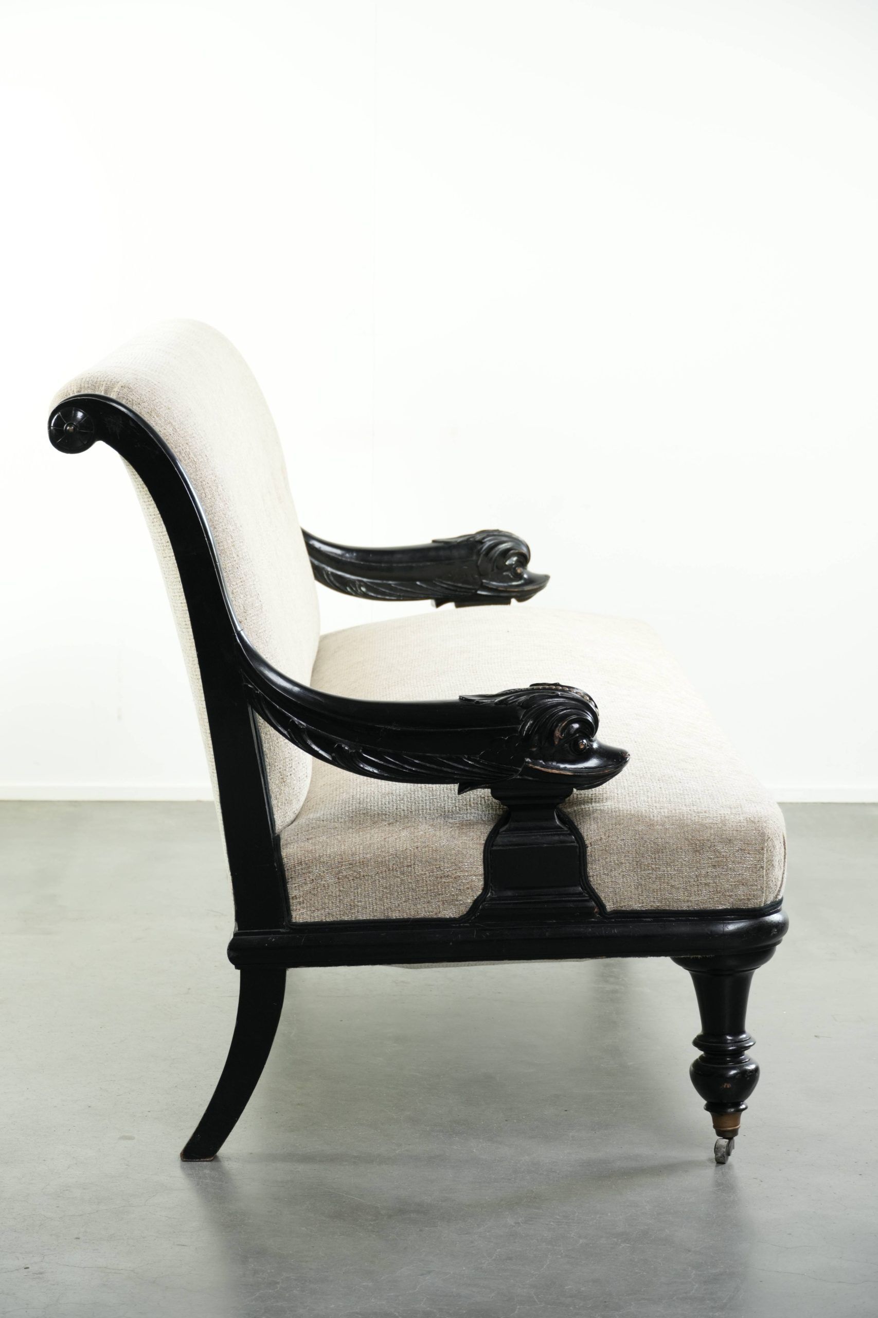 French sofa from the 19th century in Empire style with detailed armrests