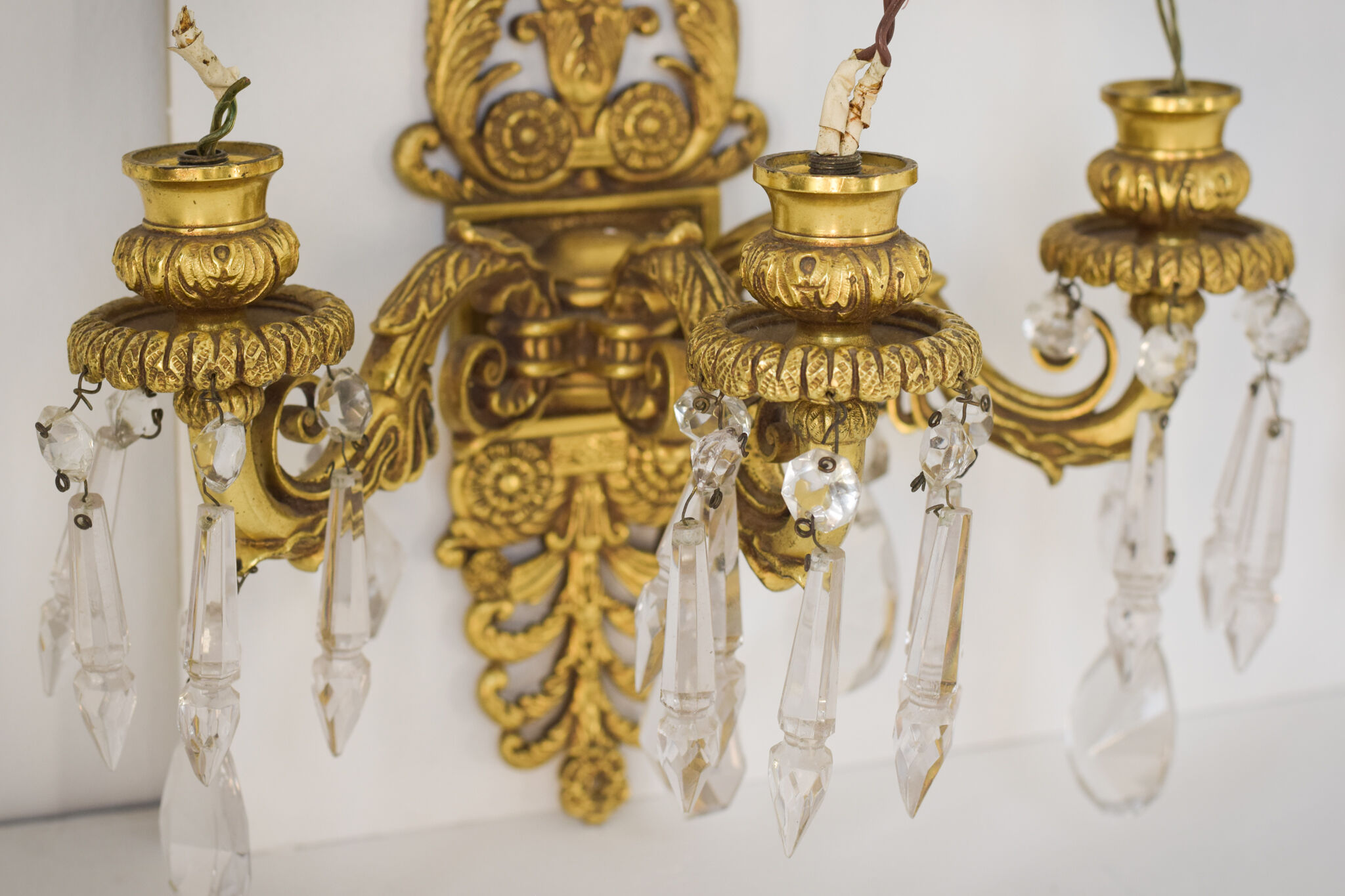 Two bronze and cut glass wall-mounted chandeliers