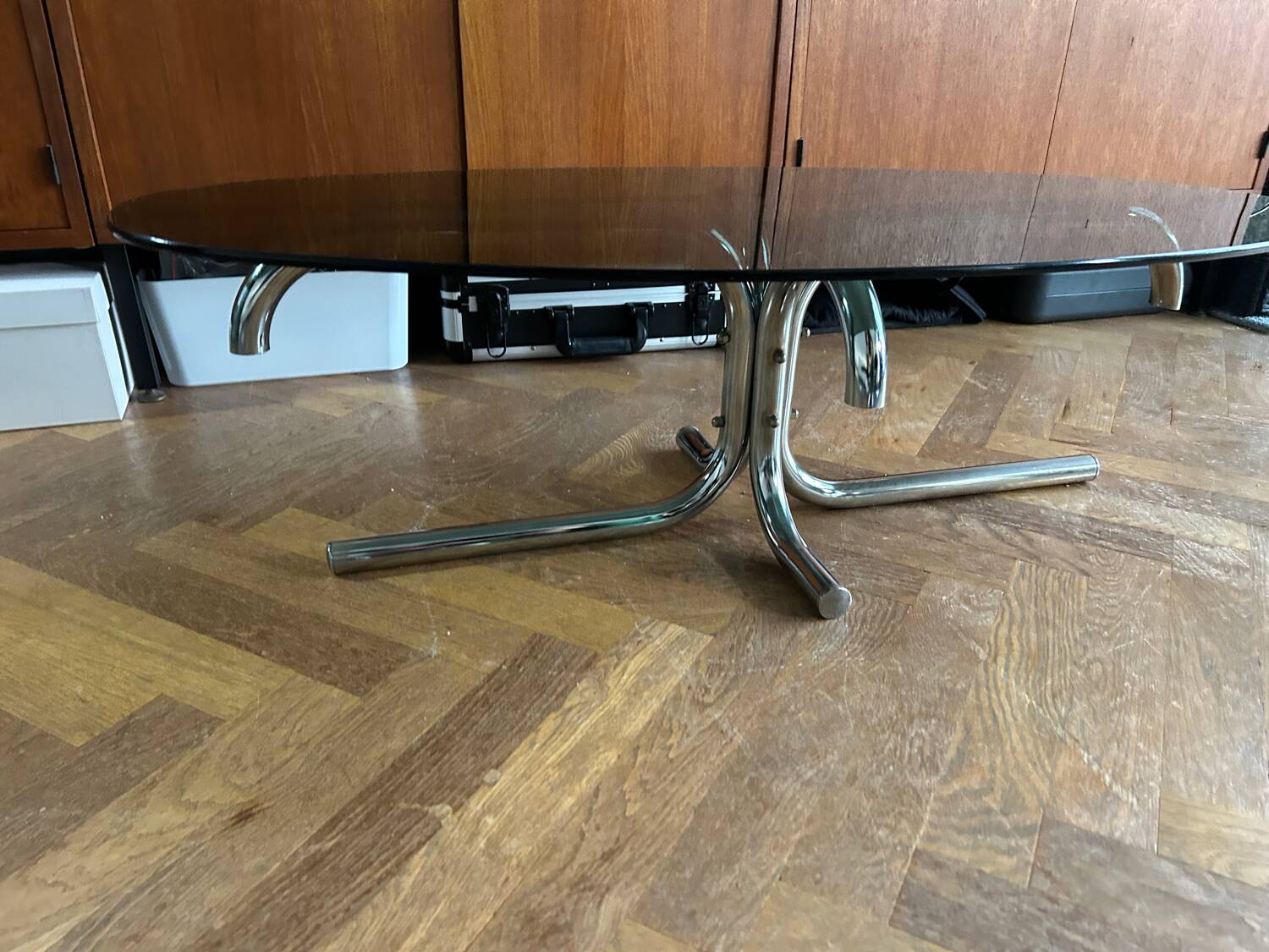 70s design oval coffee table in smoked black glass with chrome legs.