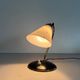 Mid-century bedside lamp in black metal and brass, 1950s, Germany