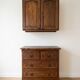 Set of chest of drawers and tall antique furniture in dark oak.