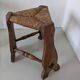 Low tripod farm stool in wood and straw