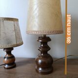 Bedside lamp with turned wooden base, chic rustic leather shade.