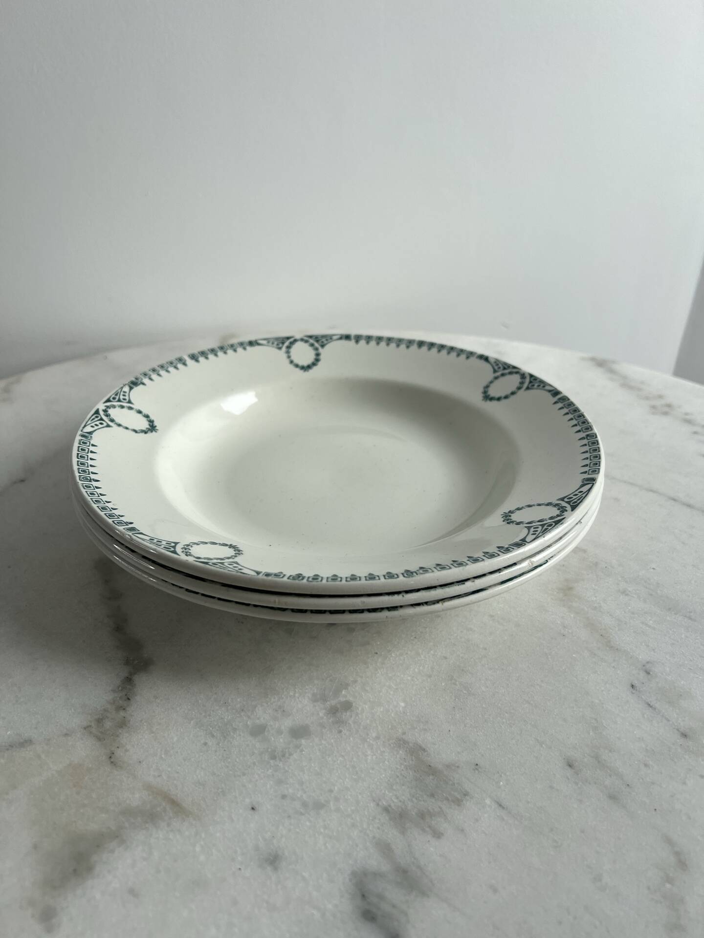Set of 3 St Amand deep plates with green crown decoration.