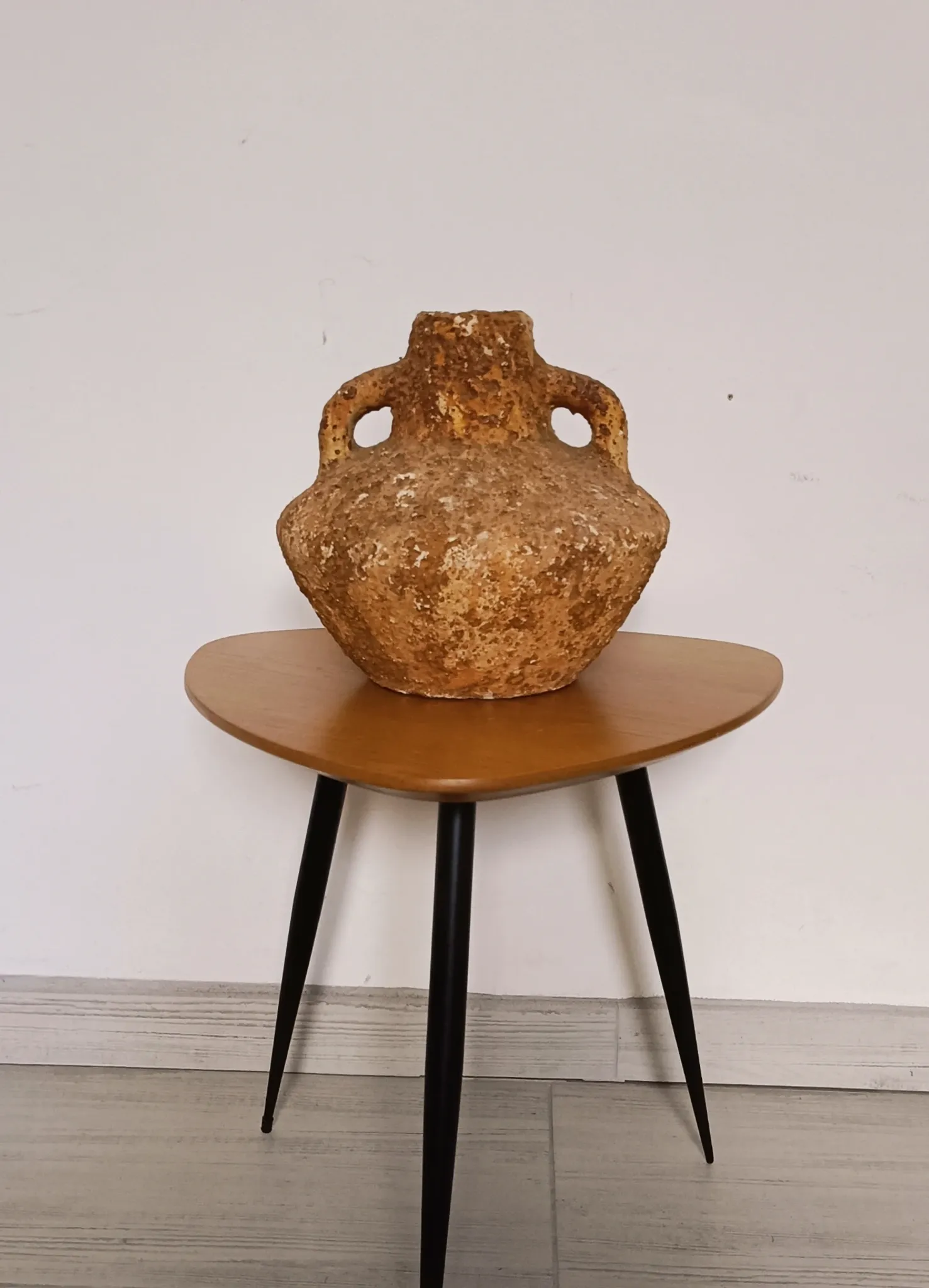 Textured terracotta vase in wabi-sabi style