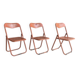 Trio of orange metal folding chairs - vintage