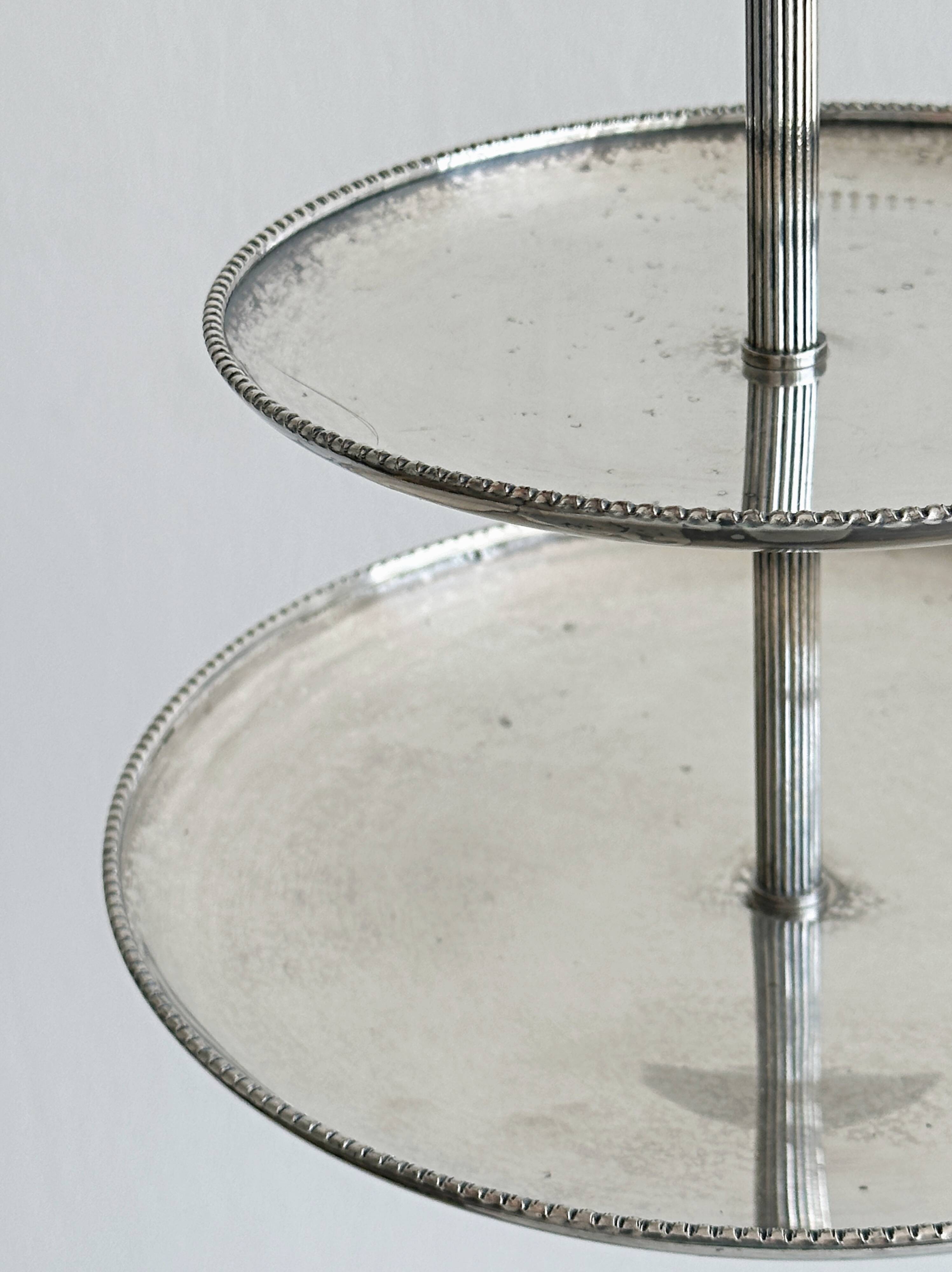 Vintage three-tiered serving stand in patinated silver metal.