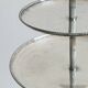 Vintage three-tiered serving stand in patinated silver metal.