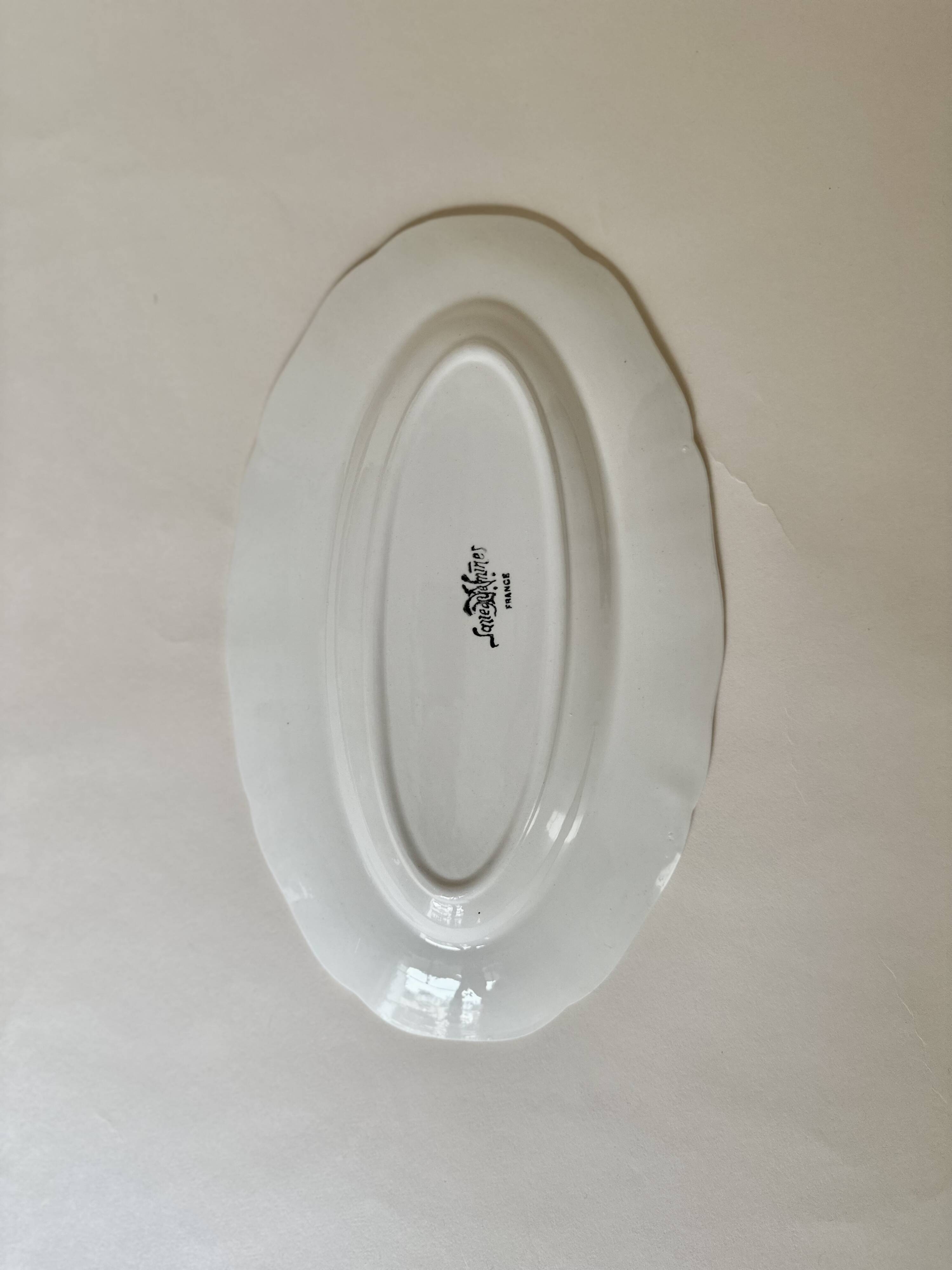 Shaped plates and dishes in Sarreguemines earthenware.