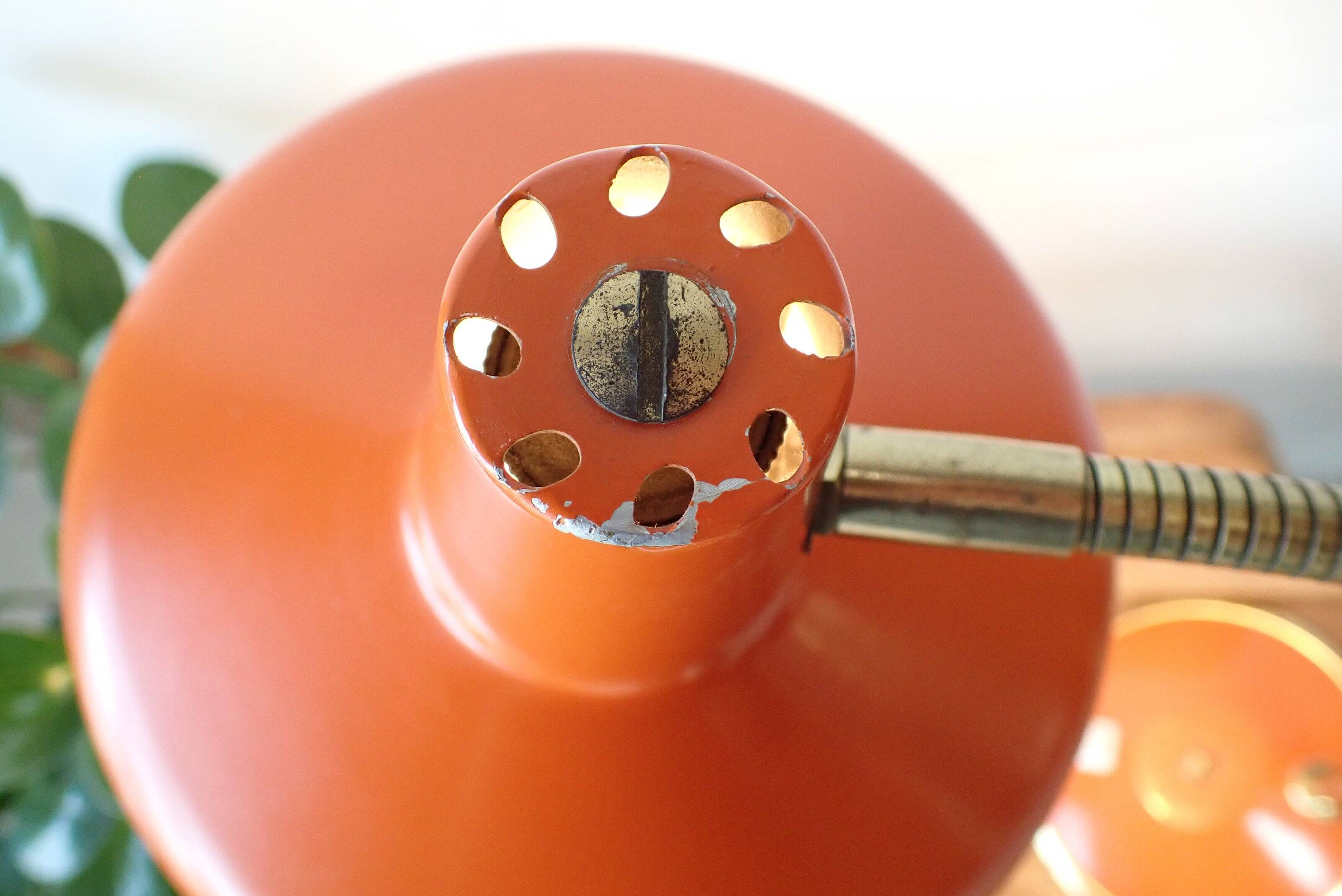 Vintage adjustable lamp, orange, made of metal.