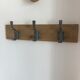 Three-hooked patères on blond oak from a local school in the 50s/60s