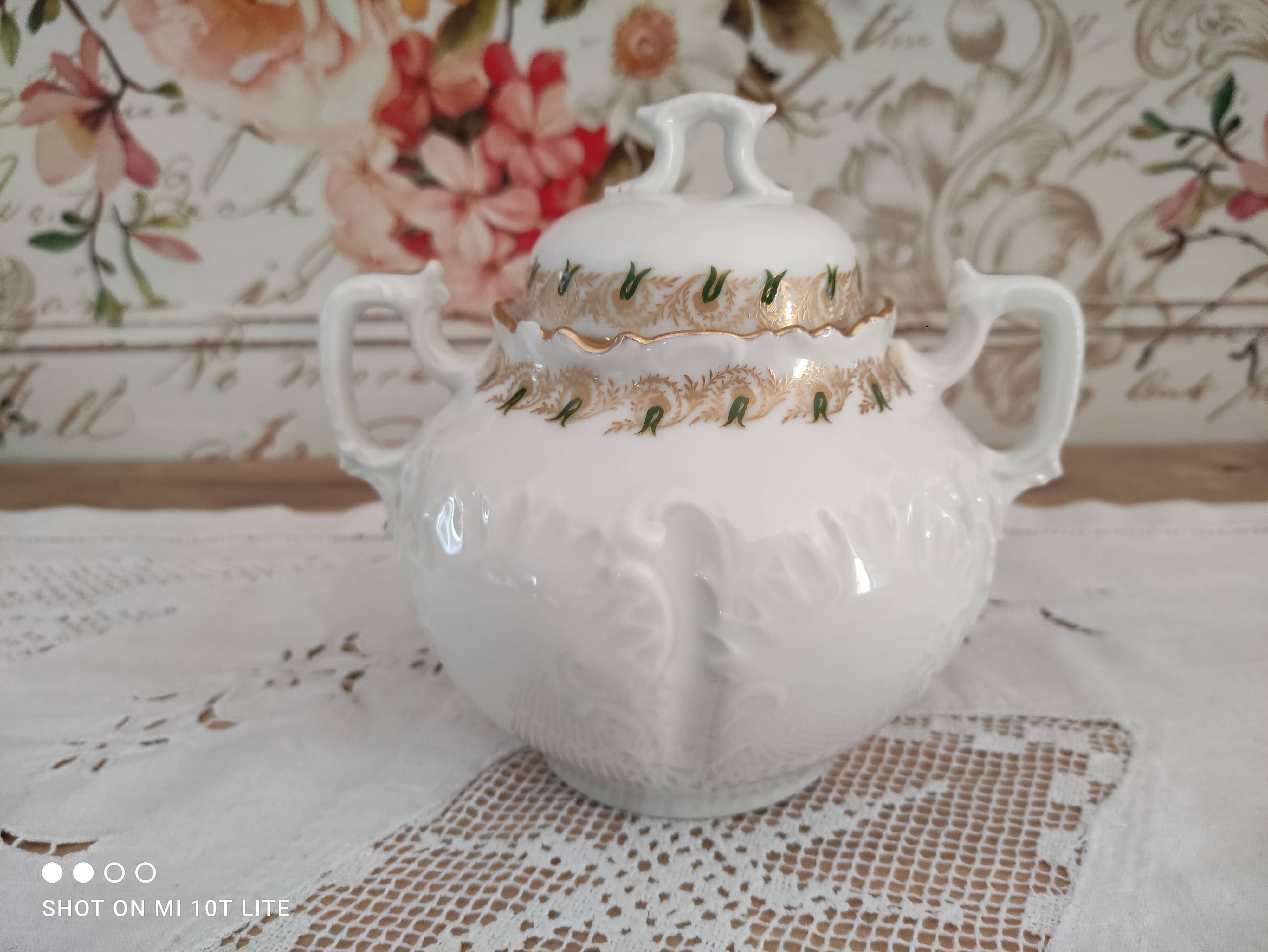White porcelain sugar bowl decoration in relief and green and gold frieze