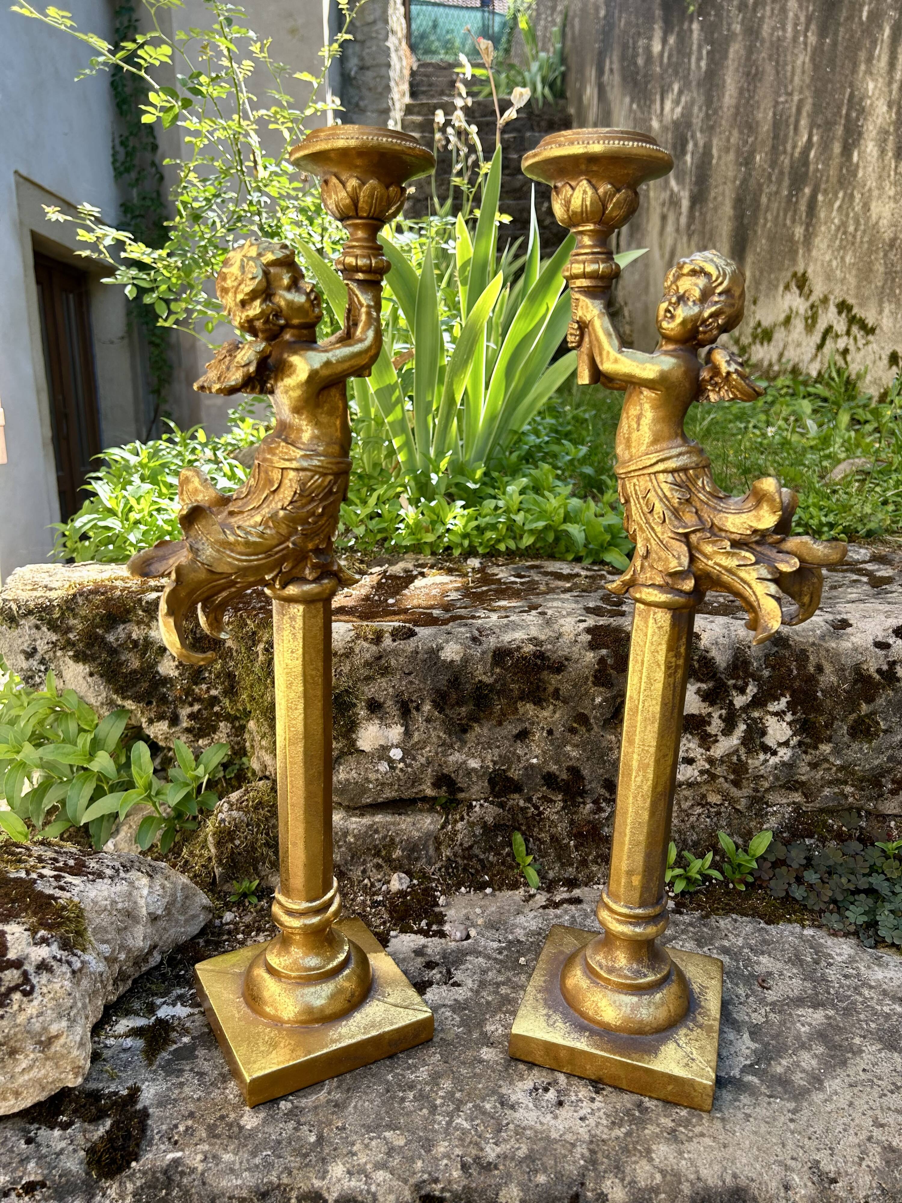 Pair of large candlesticks with cherubs