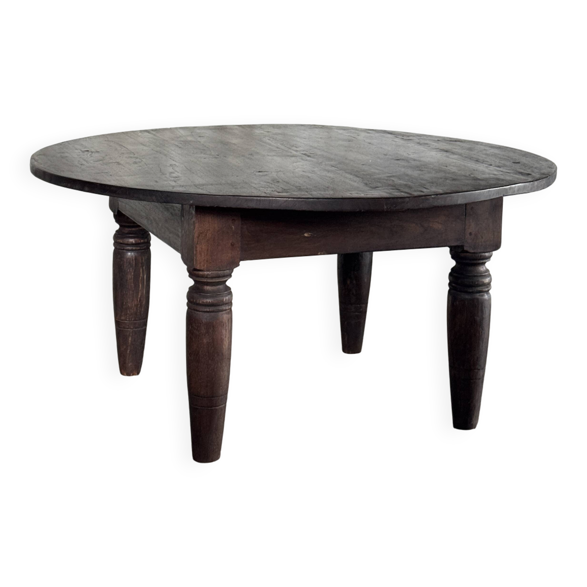 Antique round coffee table in Indonesian teak with turned legs.