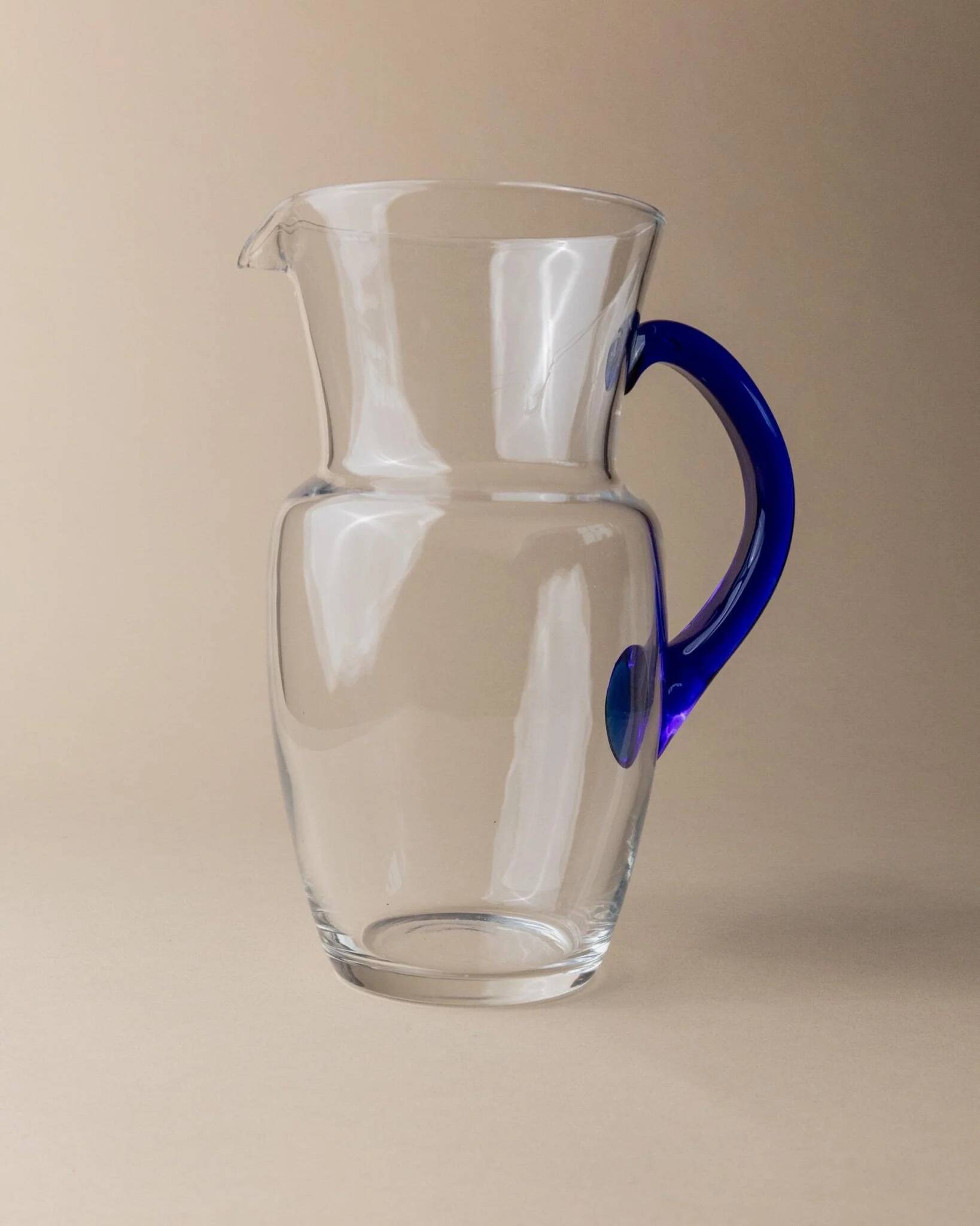 Vintage glass pitcher - clear glass with blue handle - Mid-Century design from Italy in the 1970s - elegant table decoration, retro gift idea.