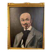 Portrait of a dandy with a moustache from the early 20th century.