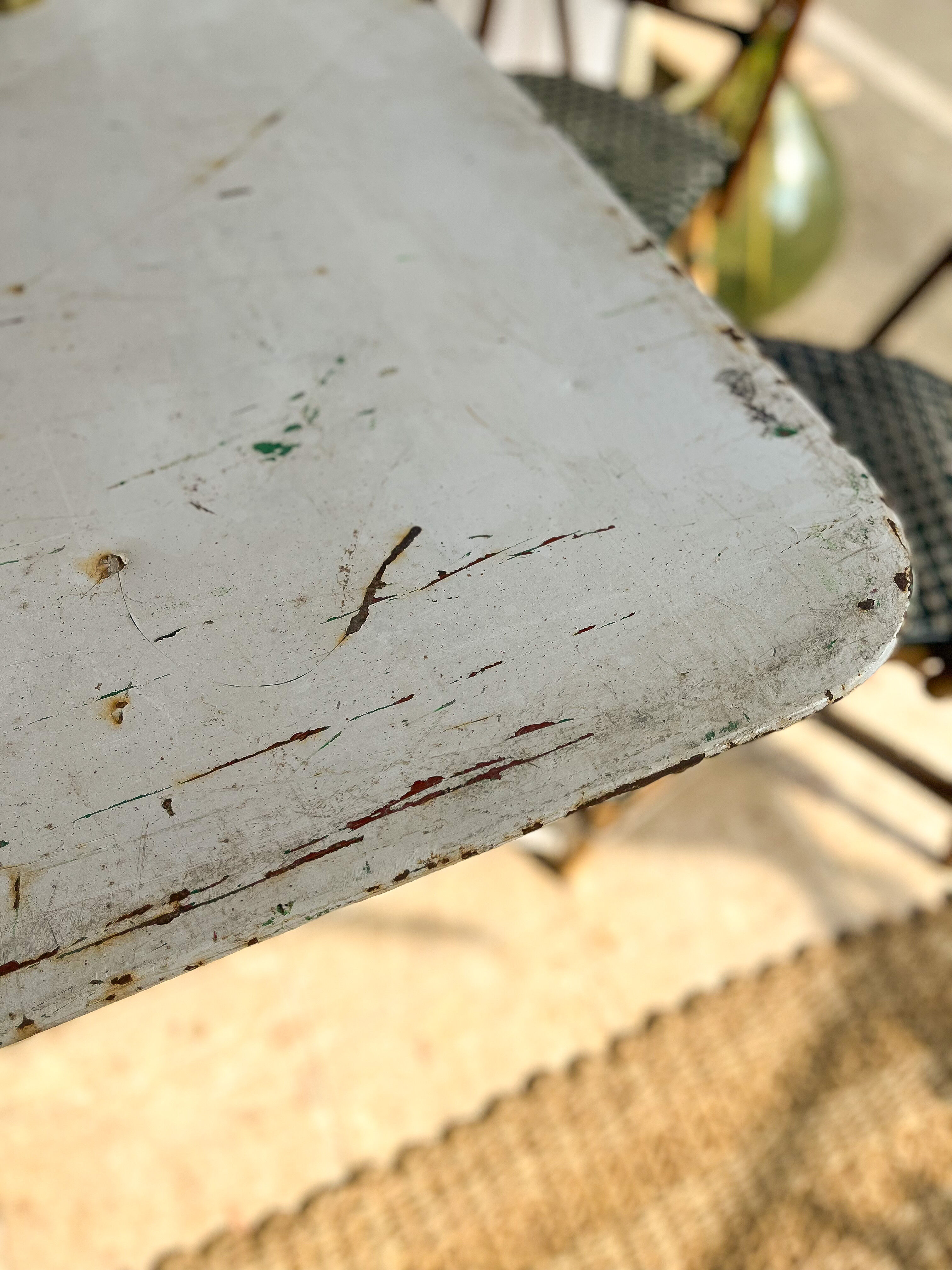 White folding metal bistro table