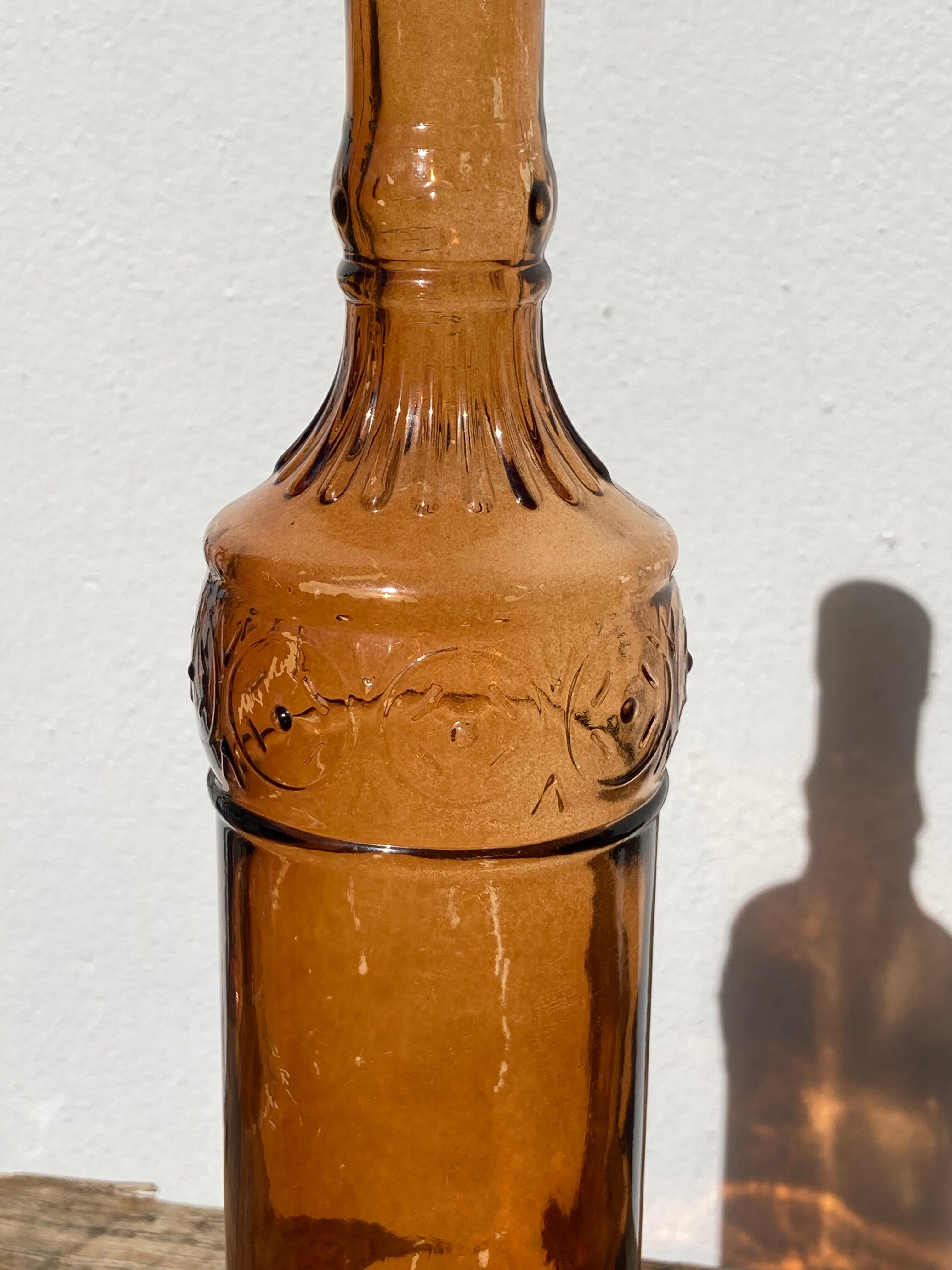 Vintage amber bottle in patterned brown glass