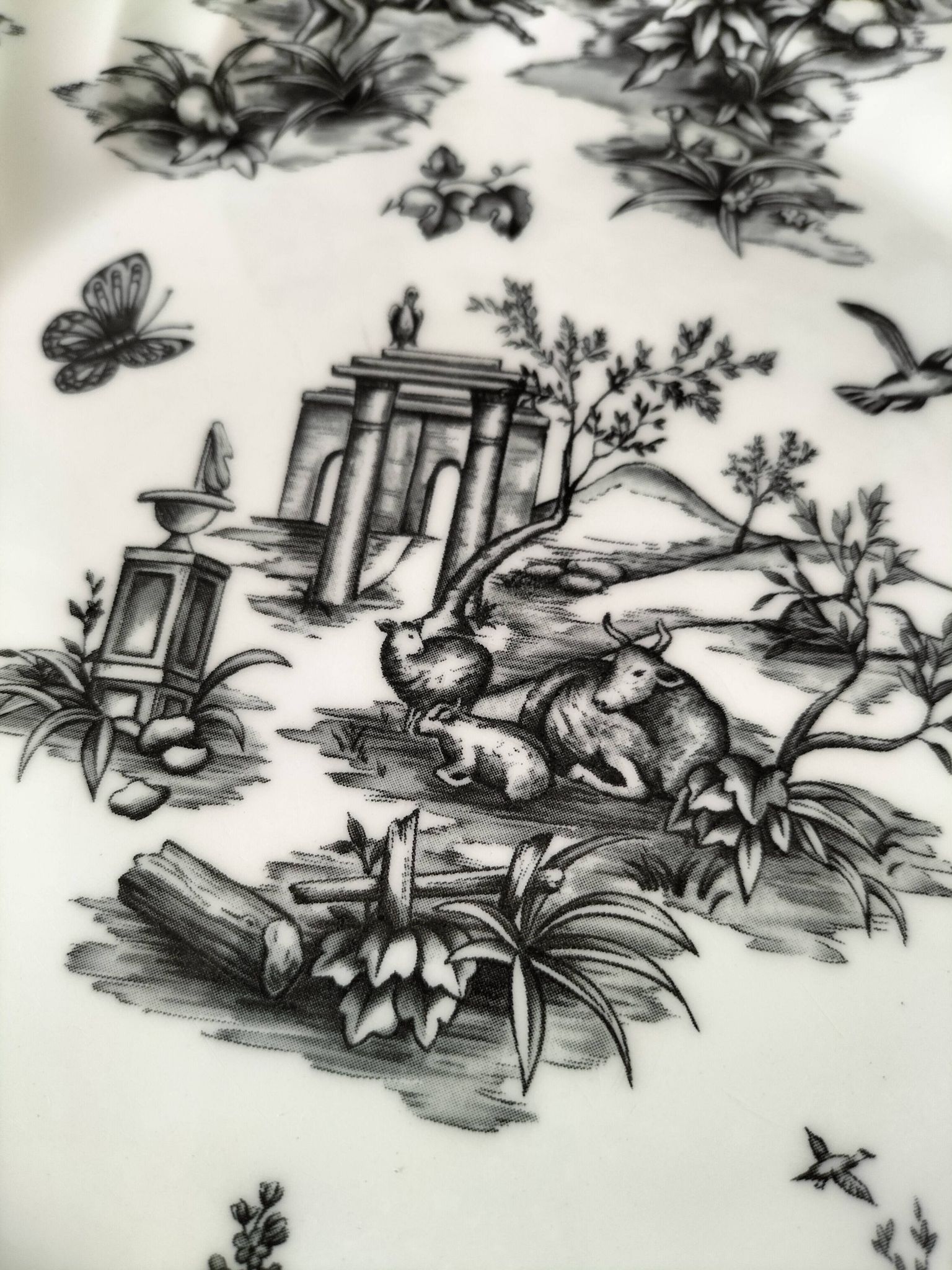 Set of black and white plates in the style of toile de Jouy.