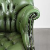 Large green cowhide Chesterfield office chair in English style on wheels