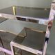 Italian shelf in gold-plated metal and smoked glass
