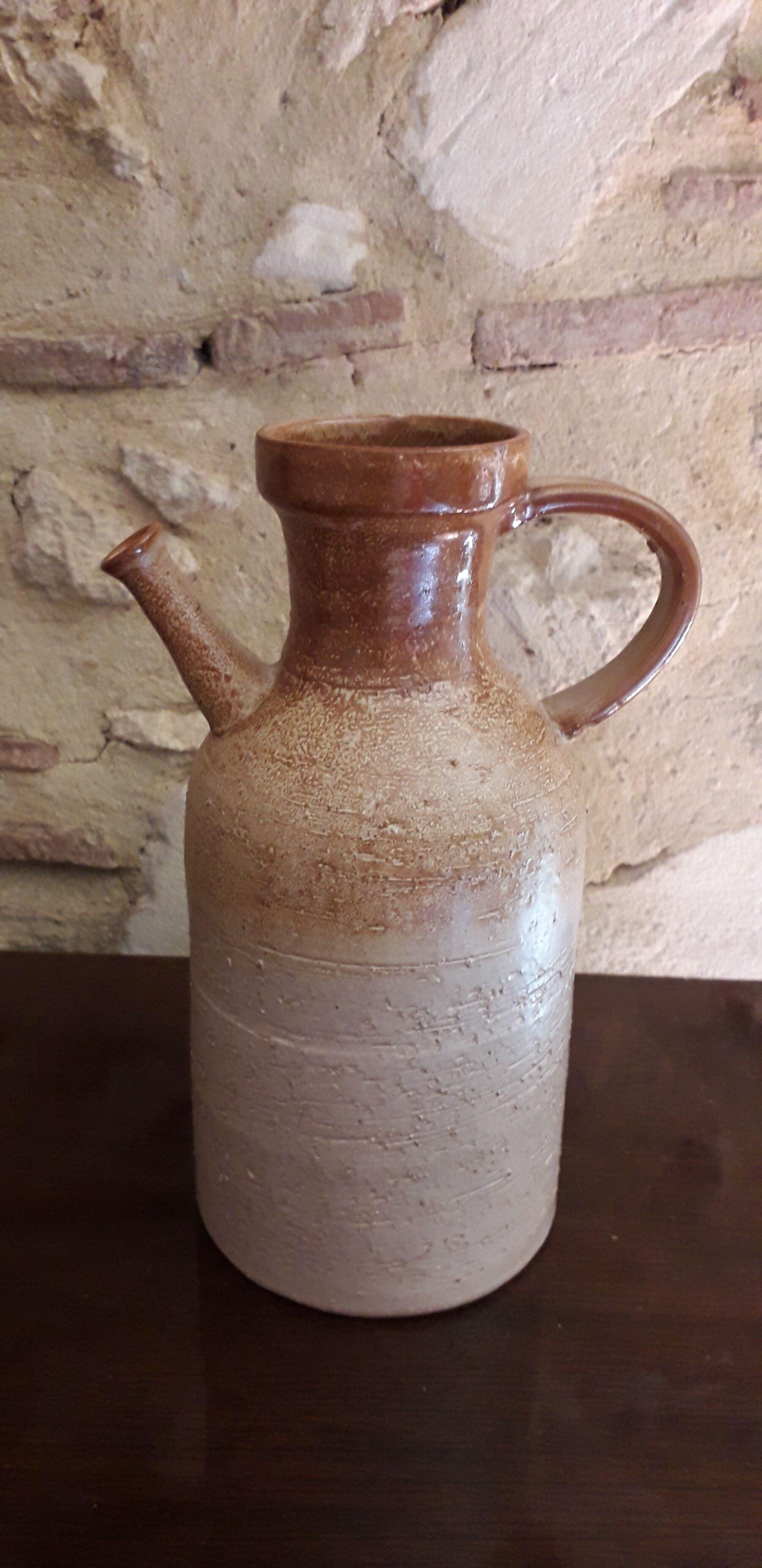 Vintage kid jug in two-tone sandstone with a handle and spout