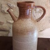 Vintage kid jug in two-tone sandstone with a handle and spout