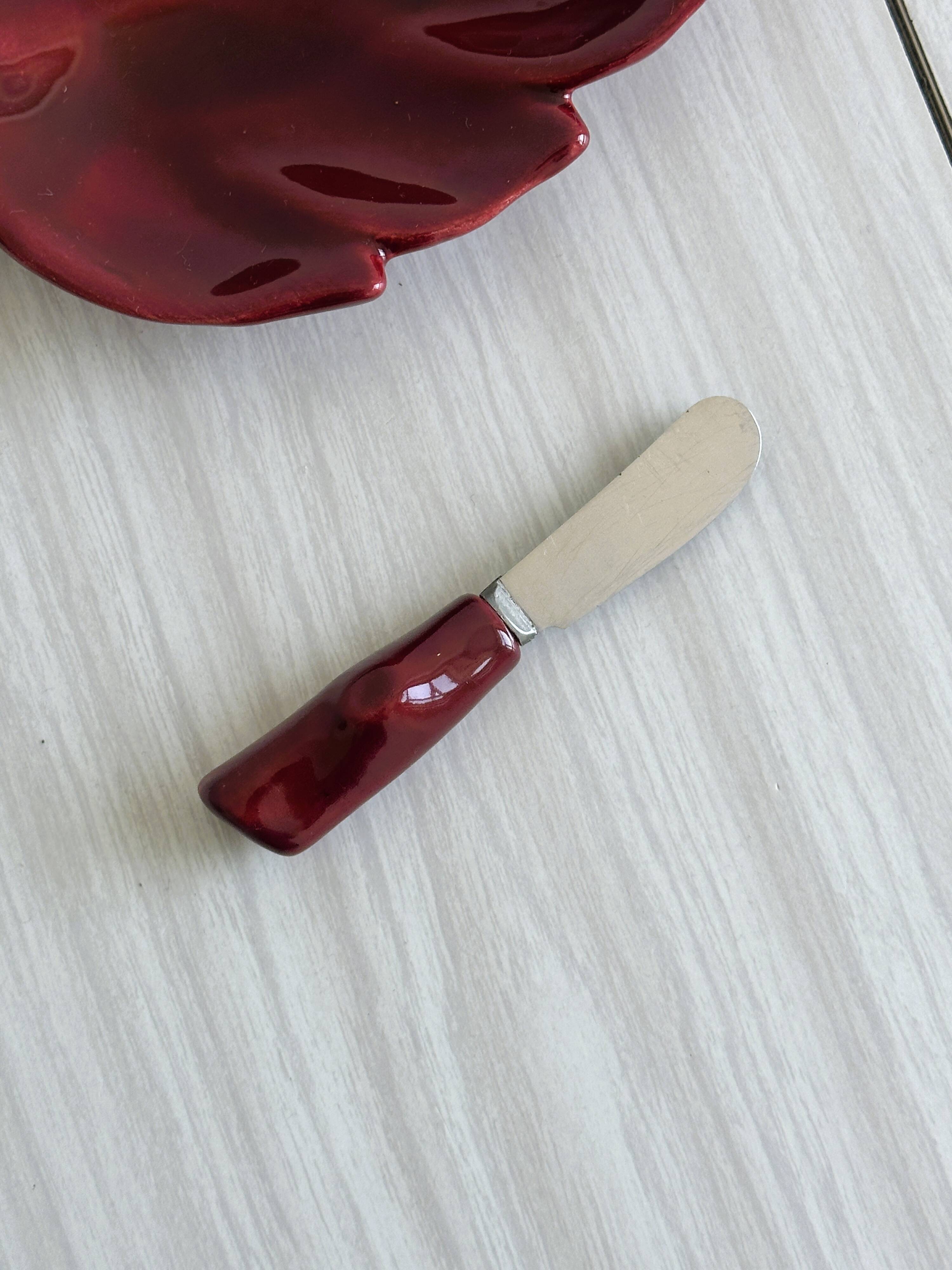 Red ceramic butter dish with knife