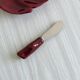 Red ceramic butter dish with knife