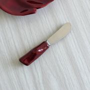 Red ceramic butter dish with knife