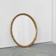 Oval mirror with gilded wood from the 1960s.