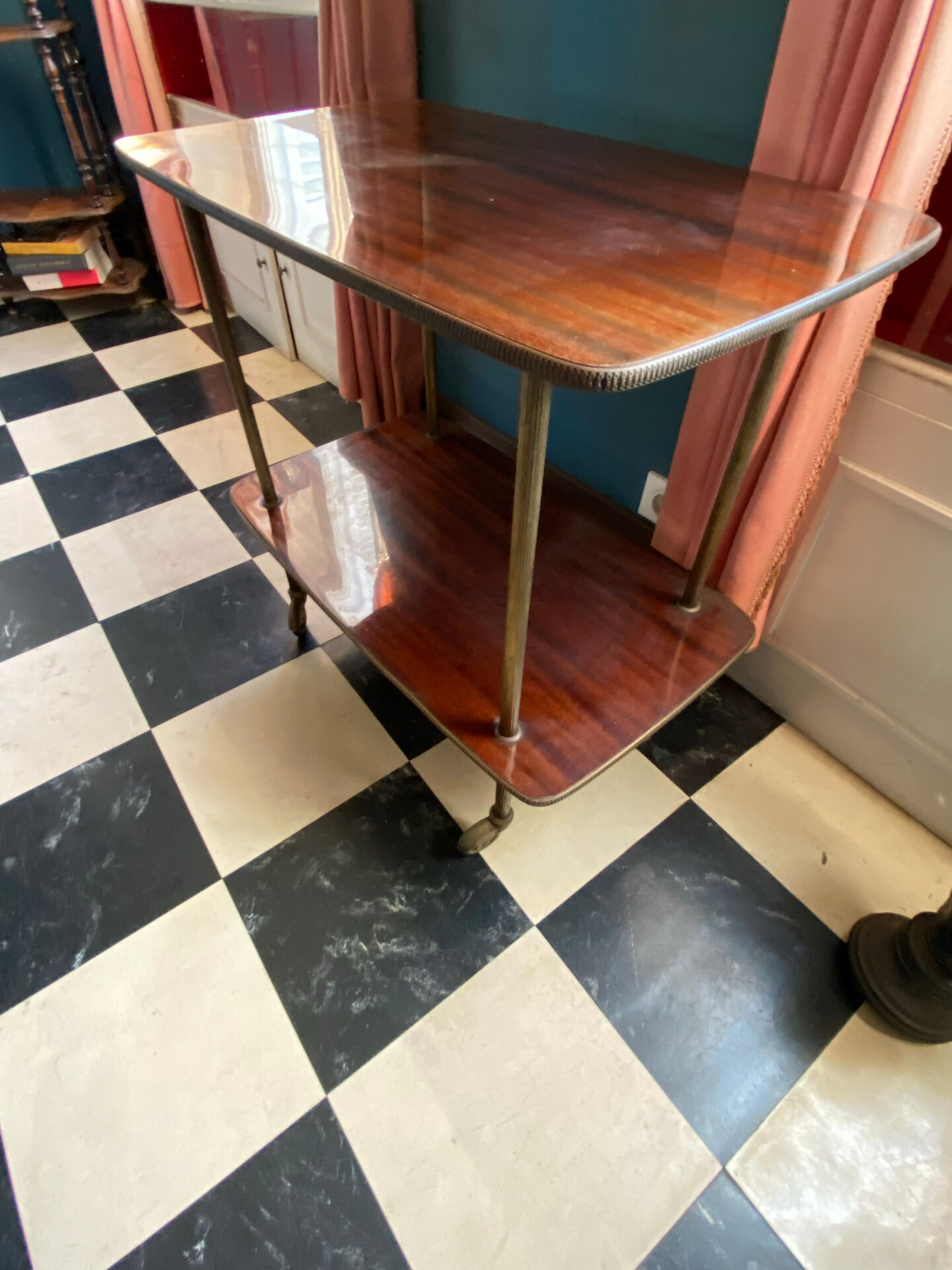 Elegant vintage serving trolley on wheels, two wooden shelves.